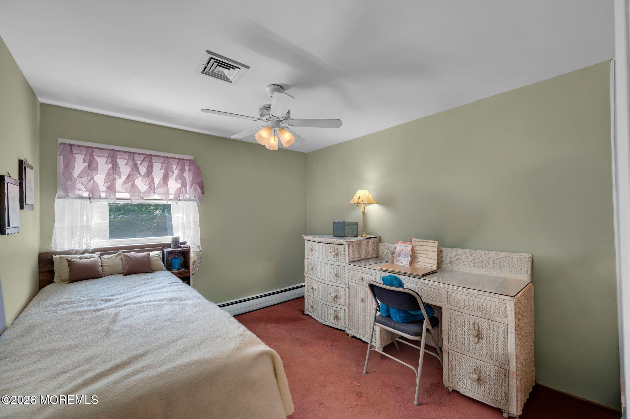 2604 Logan Road Asbury Park, NJ 07712 - Photo 18 of 39 a bedroom with a bed and a chandelier