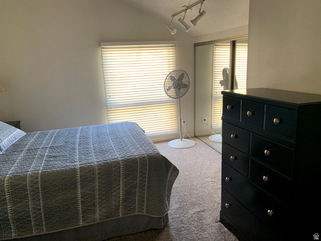 860 South Village Road, Unit B11 St. George, UT 84770 - Photo 9 of 19 Bedroom featuring light carpet and vaulted ceiling