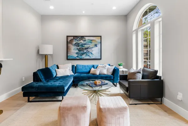 a kitchen with a sink a refrigerator and chairs