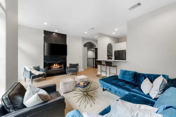 a living room with furniture ceiling fan and a window