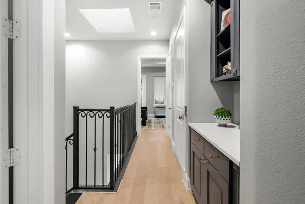 a bedroom with a bed a mirror on desk and a window