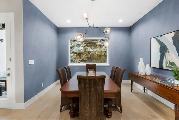 a kitchen with stainless steel appliances granite countertop a sink a stove and a refrigerator