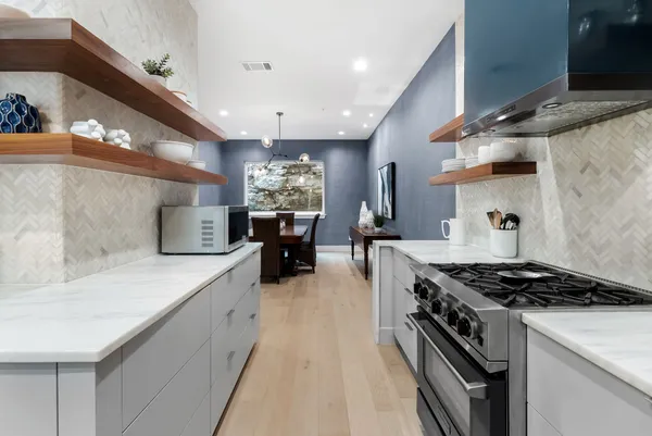 a view of staircase with railing and white walls