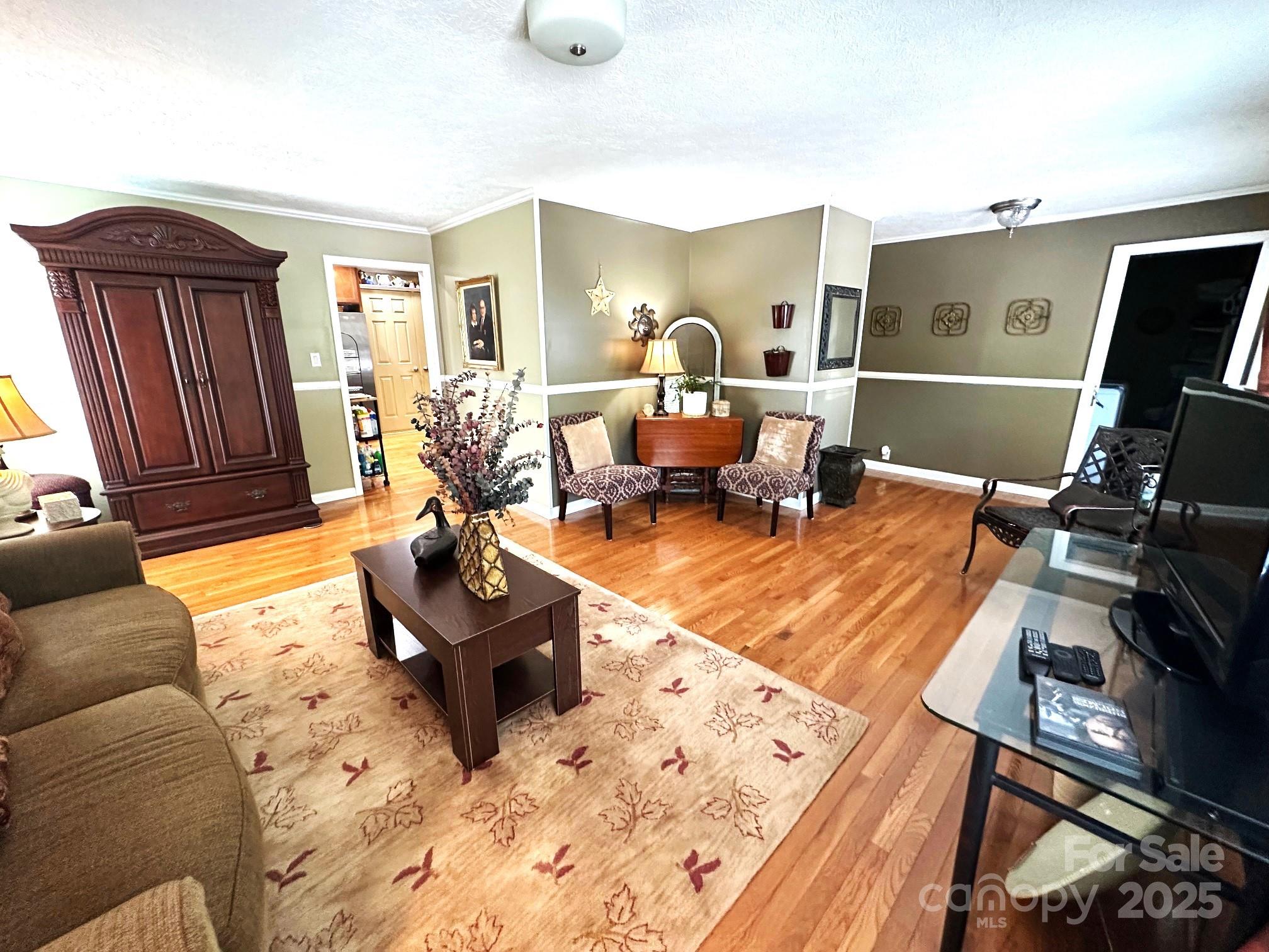25 Norman Road Fletcher, NC 28732 - Photo 11 of 47 a living room with furniture hard wood floor and a flat screen tv