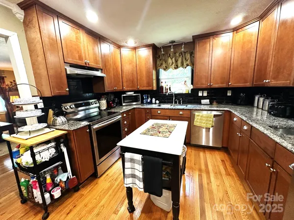 a kitchen with sink refrigerator and window