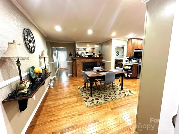 a dining room with a wooden table and chairs