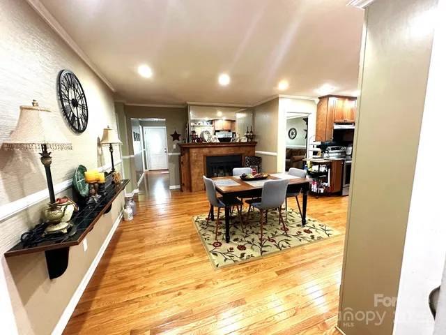 a dining room with a wooden table and chairs