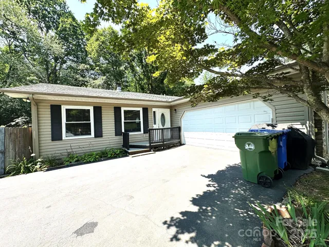 a view of a house with backyard sitting area and garden