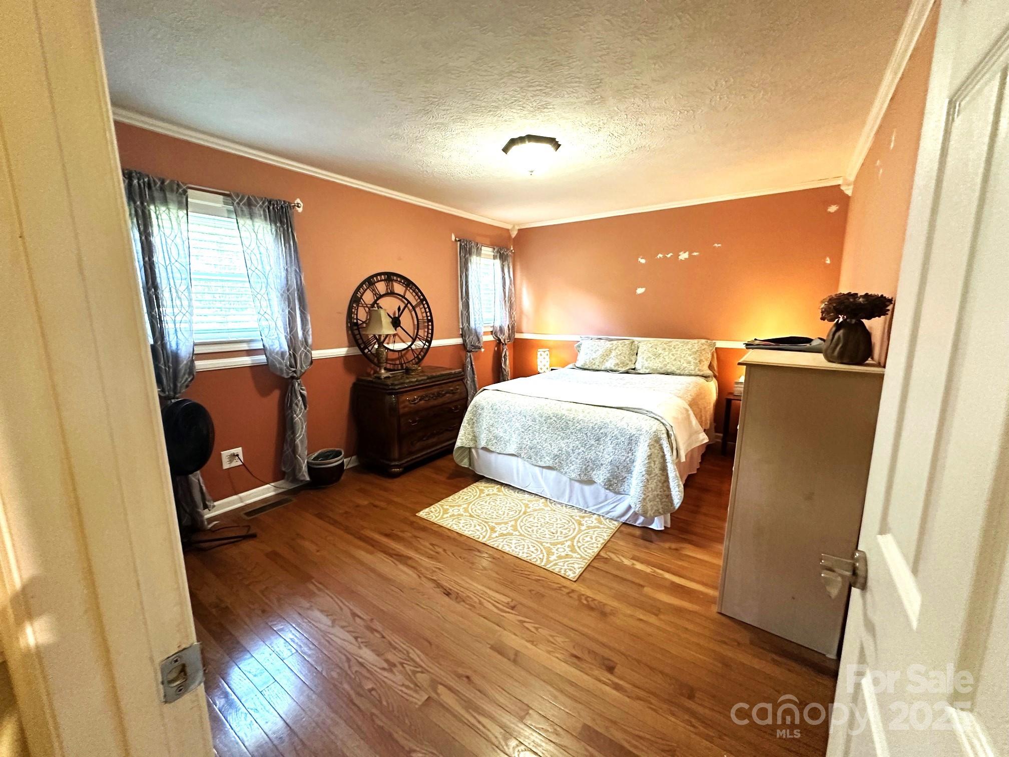 25 Norman Road Fletcher, NC 28732 - Photo 22 of 47 a bedroom with a bed and wooden floor