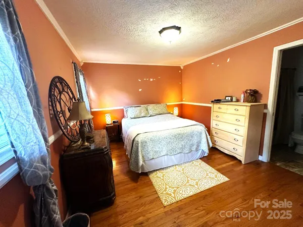 a bed room with a bed and a dresser