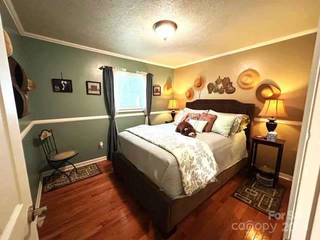 a bed sitting in a bedroom next to a window