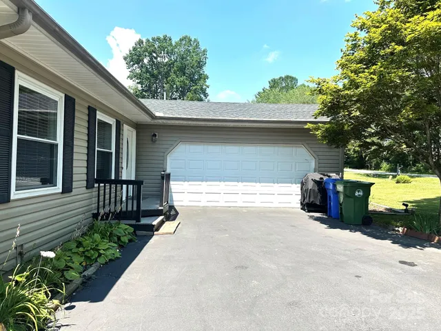 a view of a house with a yard and garage