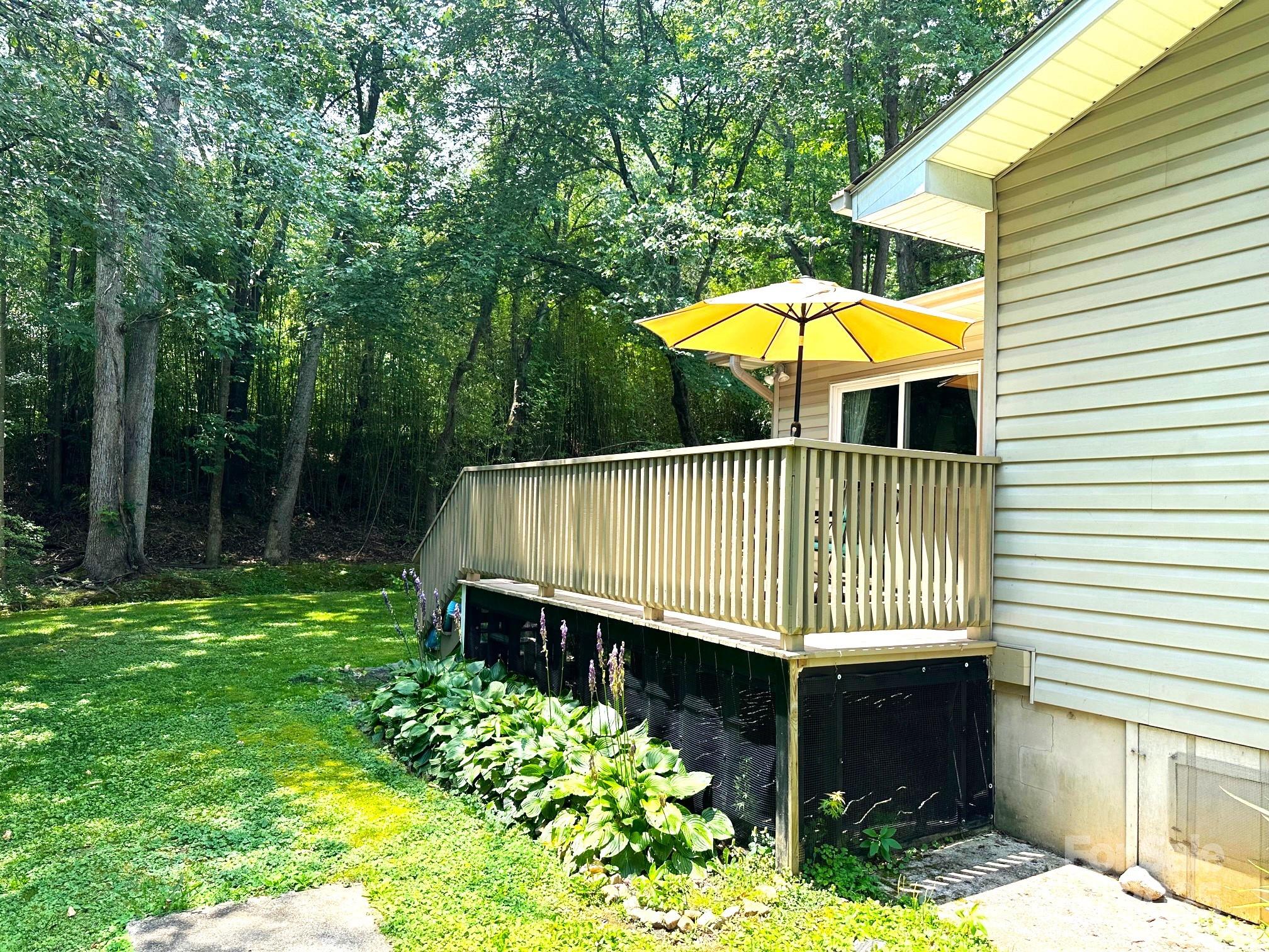 25 Norman Road Fletcher, NC 28732 - Photo 34 of 47 a view of a backyard with a small deck and a garden