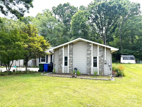a view of a house with pool and chairs