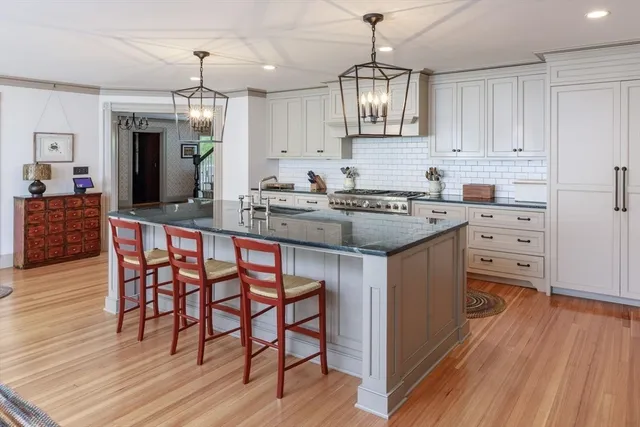 a kitchen with stainless steel appliances granite countertop wooden floors and stove