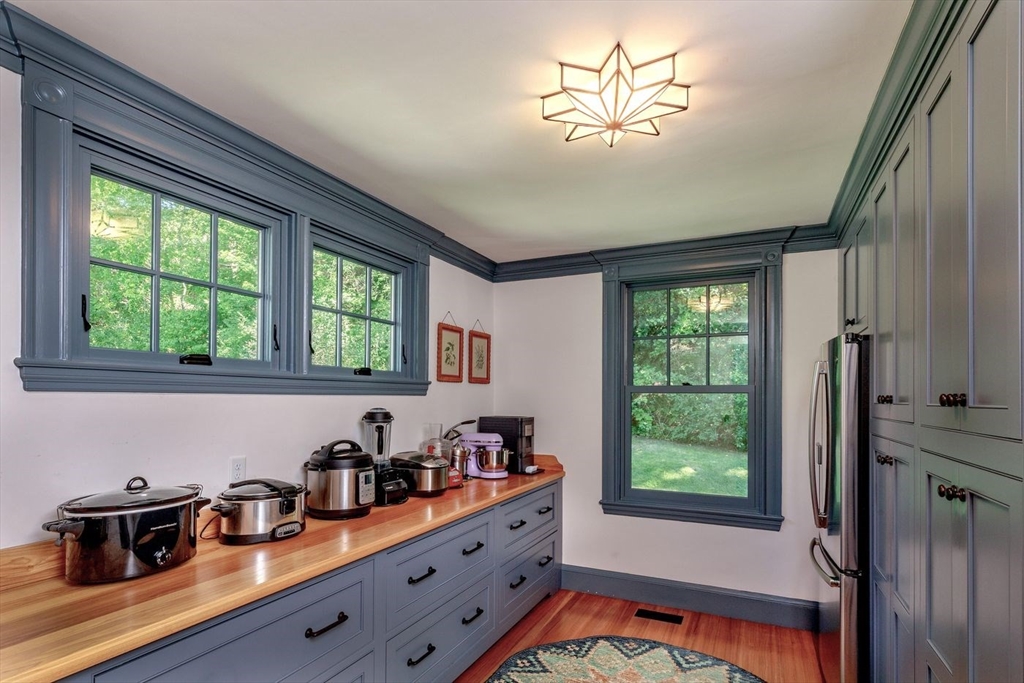 450 Summer Street Manchester, MA 01944 - Photo 13 of 42 a kitchen with stainless steel appliances a sink a stove and a window