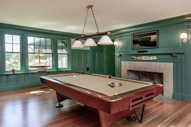 a room with pool table and windows