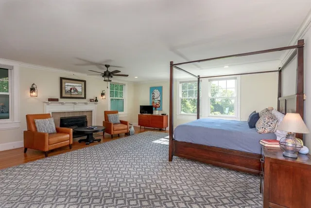 a bedroom with furniture and a fireplace