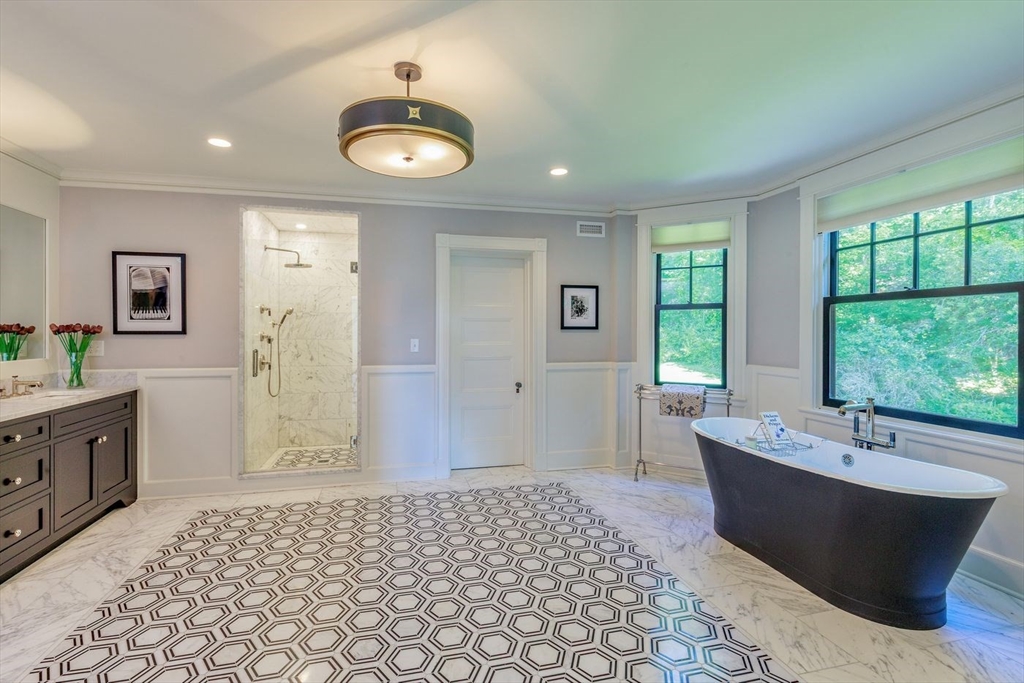 450 Summer Street Manchester, MA 01944 - Photo 18 of 42 a spacious bathroom with a tub sink and mirror