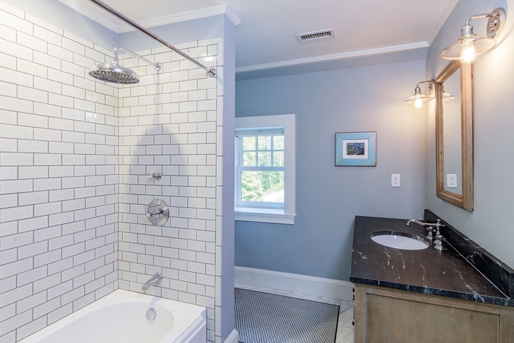 450 Summer Street Manchester, MA 01944 - Photo 20 of 42 a bathroom with a sink and a mirror