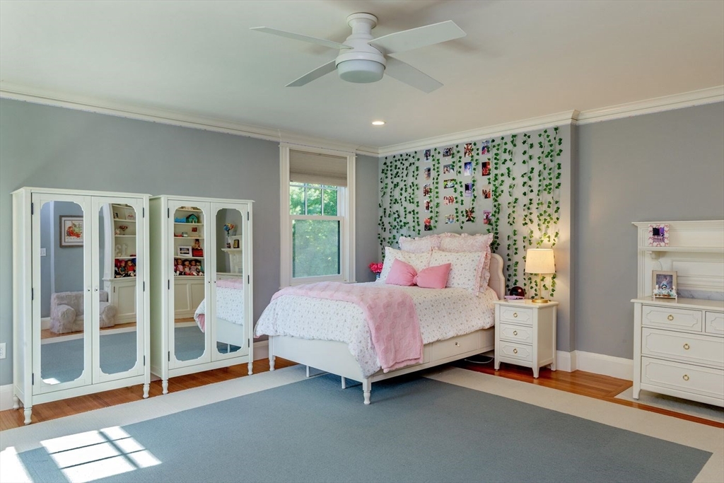 450 Summer Street Manchester, MA 01944 - Photo 21 of 42 a bedroom with a bed and wooden floor