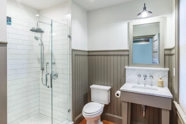 a bathroom with a toilet sink and shower