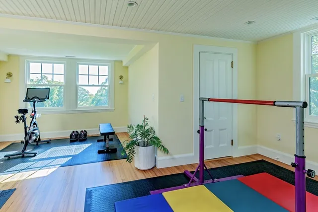 a room with lots of white walls and wooden floor