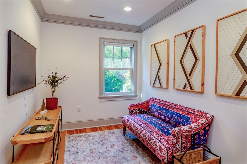 450 Summer Street Manchester, MA 01944 - Photo 32 of 42 a living room with furniture a flat screen tv and a window
