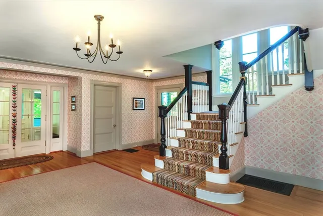 a view of entryway and hall with wooden floor