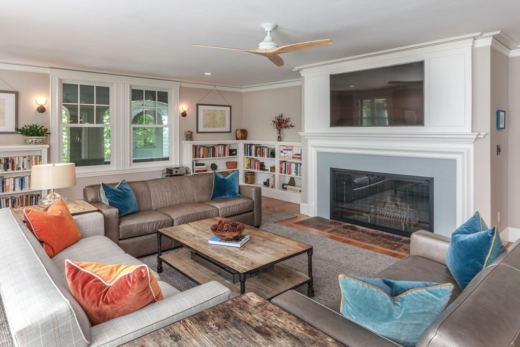450 Summer Street Manchester, MA 01944 - Photo 10 of 42 a living room with furniture a flat screen tv and a fireplace