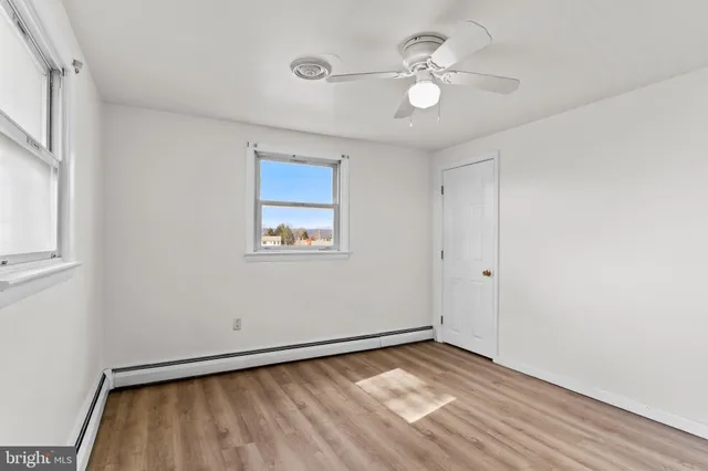 a view of a house with a big yard and large trees
