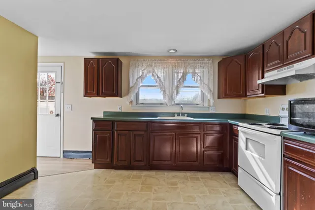 a kitchen with granite countertop a cabinets and outdoor space