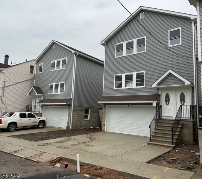 16 Robert Street Paterson, NJ 07503 - Photo 1 of 9 a front view of a house with parking