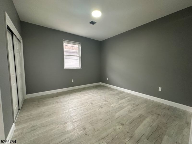 16 Robert Street Paterson, NJ 07503 - Photo 4 of 9 an empty room with a window