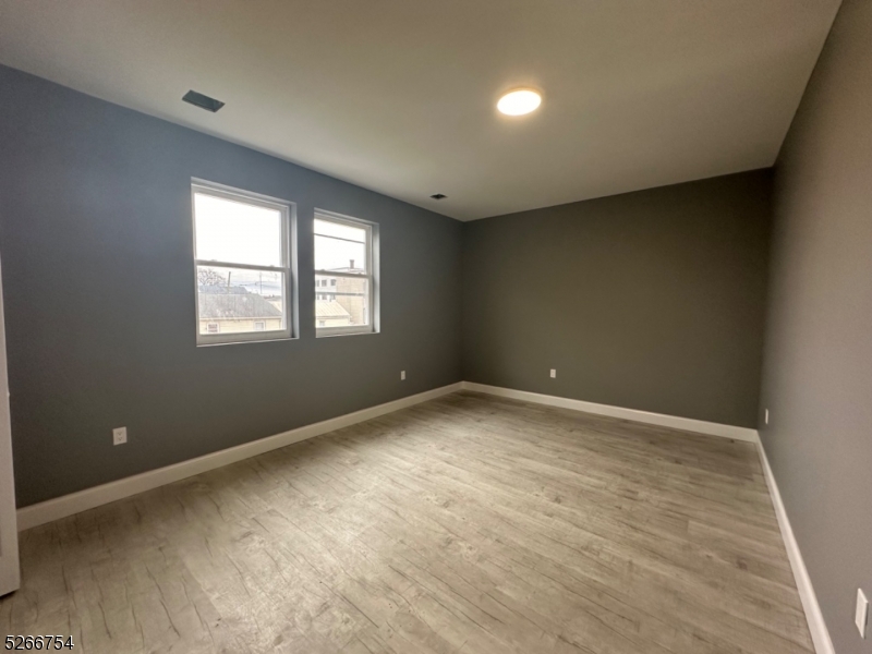 16 Robert Street Paterson, NJ 07503 - Photo 6 of 9 an empty room with windows