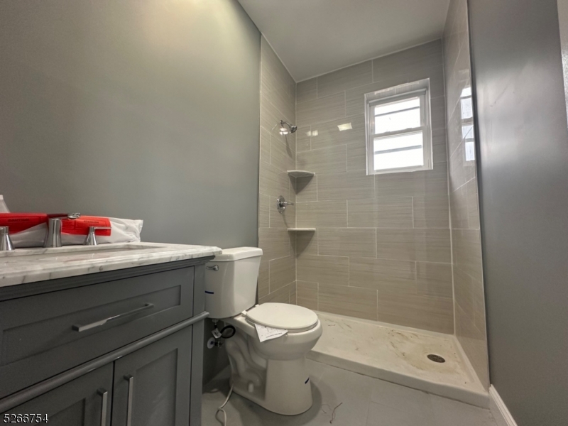 16 Robert Street Paterson, NJ 07503 - Photo 7 of 9 a bathroom with a bathtub sink mirror and toilet