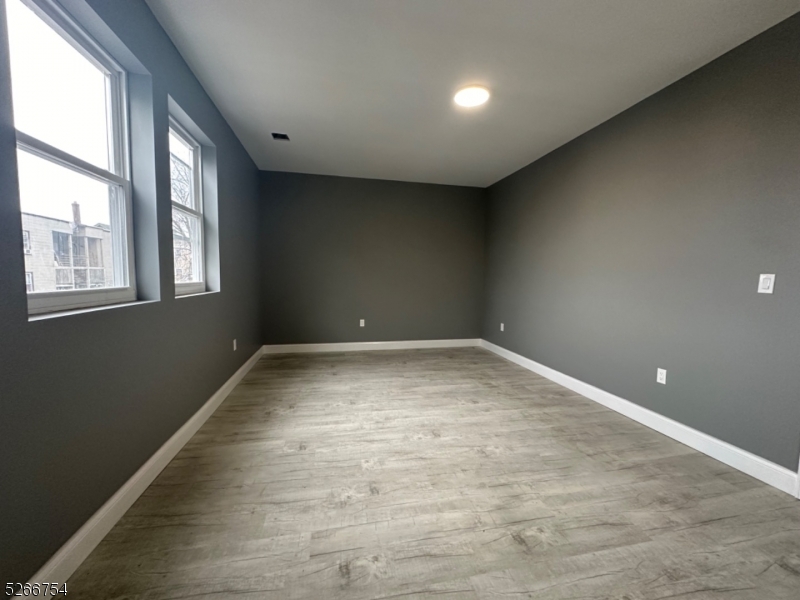 16 Robert Street Paterson, NJ 07503 - Photo 8 of 9 an empty room with a window