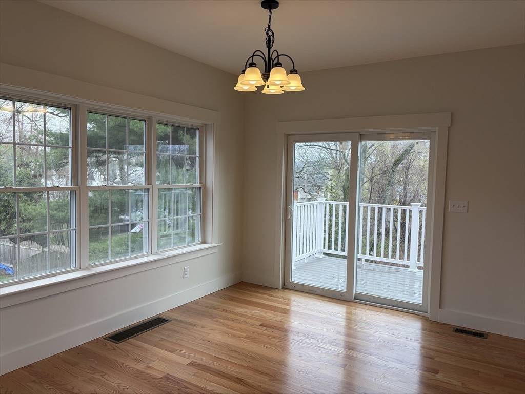 76 Valmor Street Worcester, MA 01604 - Photo 7 of 20 a view of an empty room with wooden floor and a window
