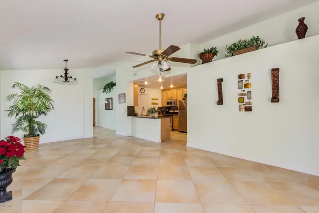 a view of a kitchen with a refrigerator a sink a potted plant