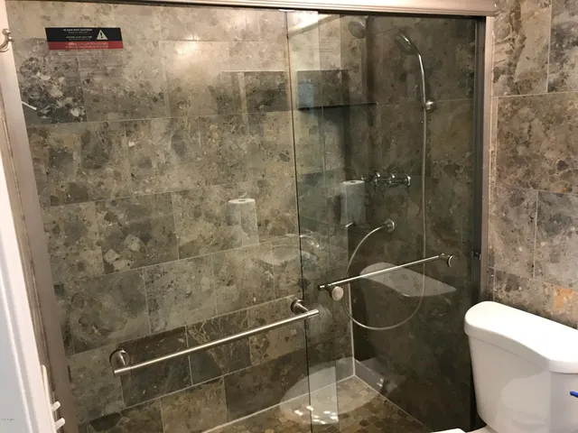 a bathroom with a toilet and a shower