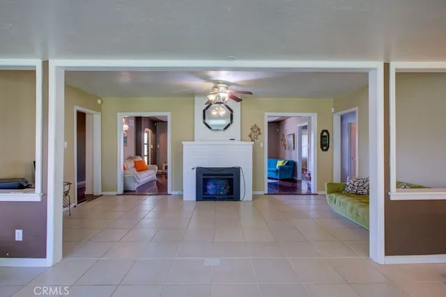 a view of a livingroom with a fireplace and a large window