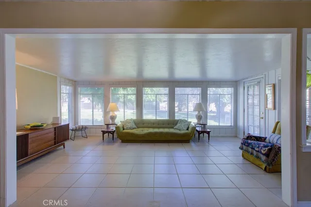 a living room with furniture and large windows