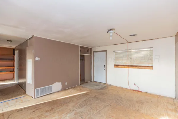 a view of a room with wooden floor and windows