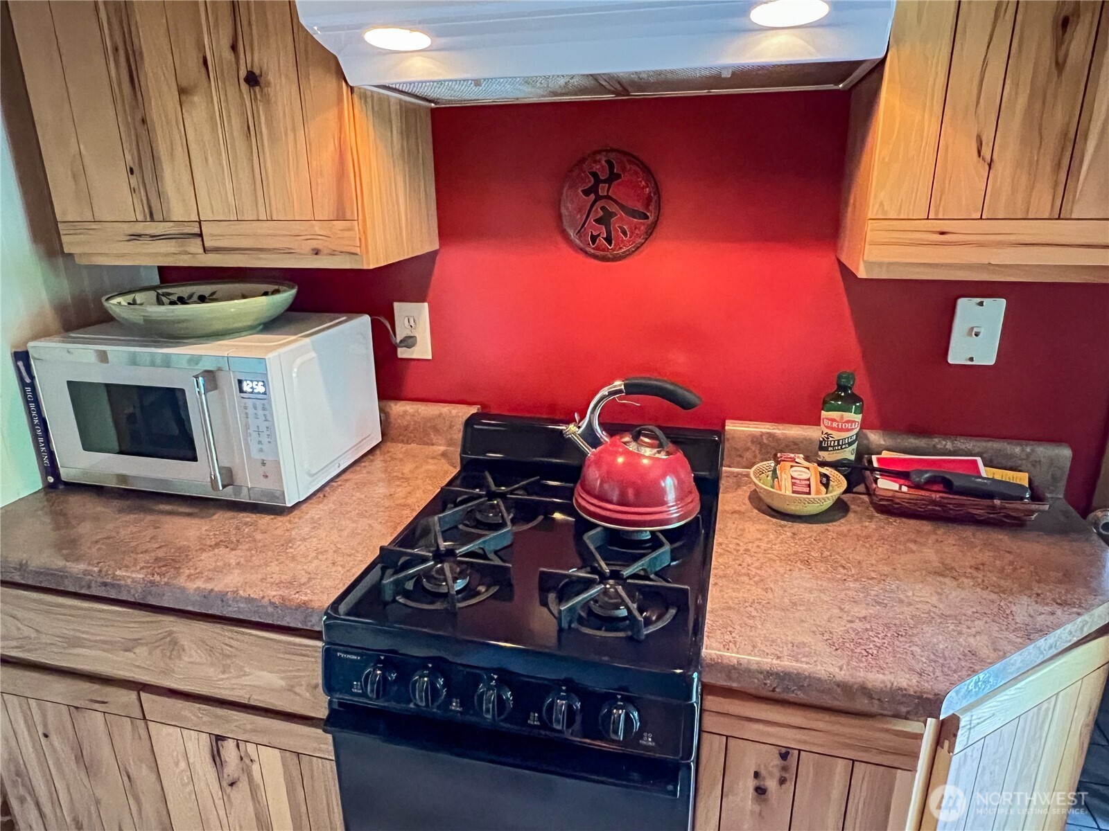 423 Lords Lake Loop Road Quilcene, WA 98376 - Photo 18 of 40 a kitchen with stainless steel appliances granite countertop a stove and a microwave