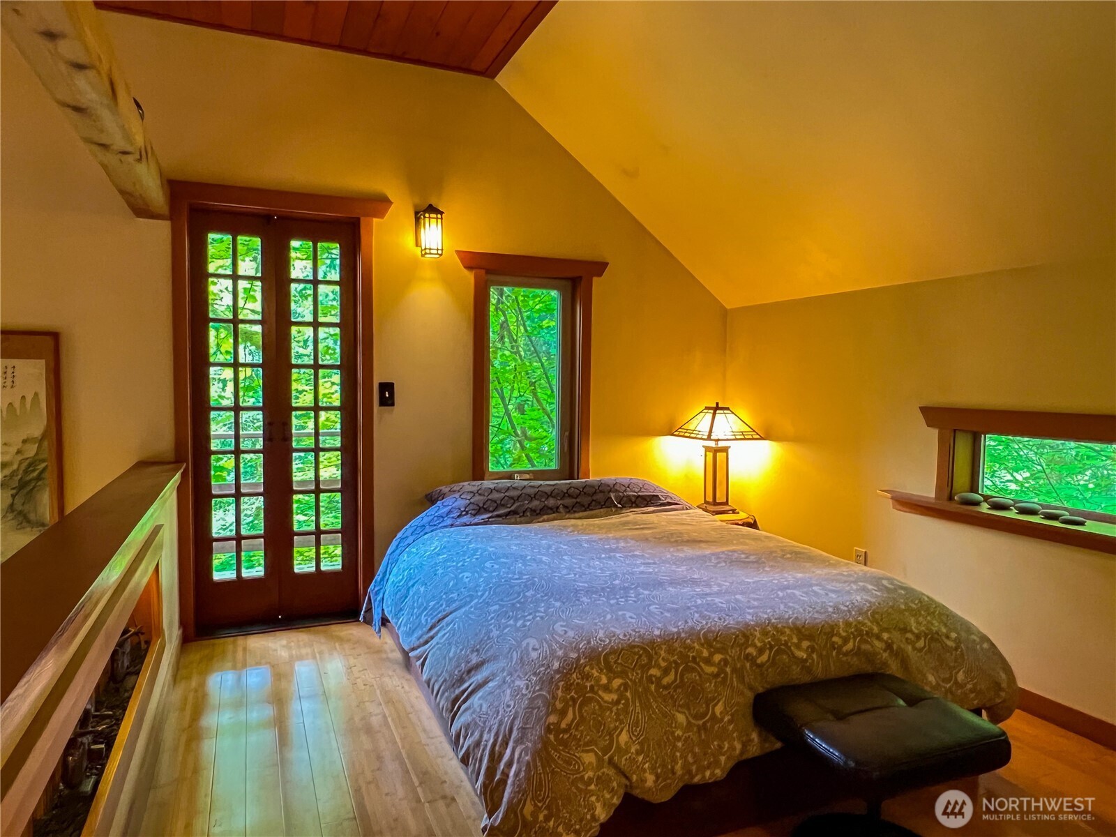 423 Lords Lake Loop Road Quilcene, WA 98376 - Photo 25 of 40 a bed sitting in a bedroom next to a window