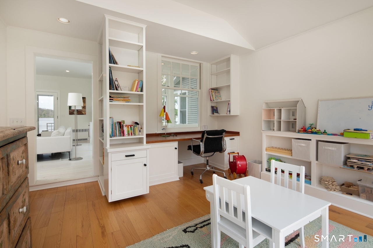 165 Interlaken Road Salisbury, CT 06039 - Photo 16 of 31 a room with furniture a baby crib and a wooden floor