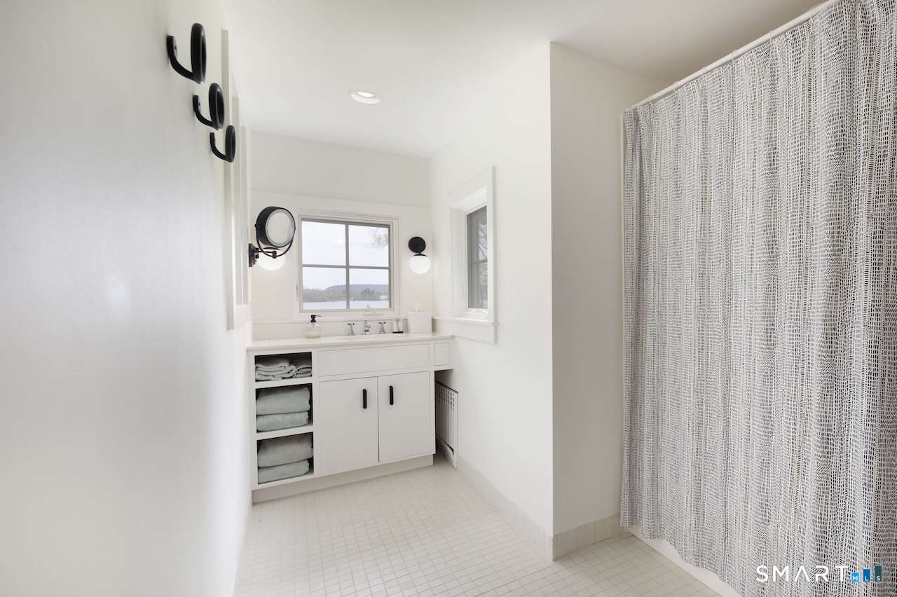 165 Interlaken Road Salisbury, CT 06039 - Photo 21 of 31 a room with a sink and a mirror
