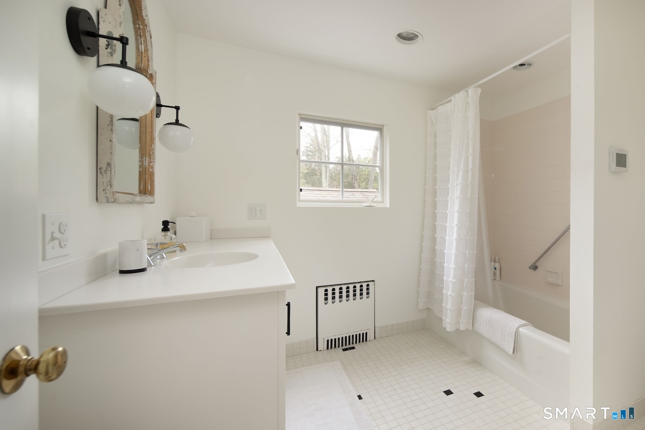 165 Interlaken Road Salisbury, CT 06039 - Photo 24 of 31 a bathroom with a sink and a mirror