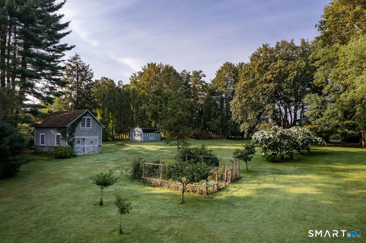 165 Interlaken Road Salisbury, CT 06039 - Photo 28 of 31 a view of a garden with a house in the background