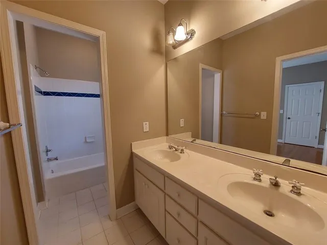 a bathroom with a sink a mirror and a bathtub